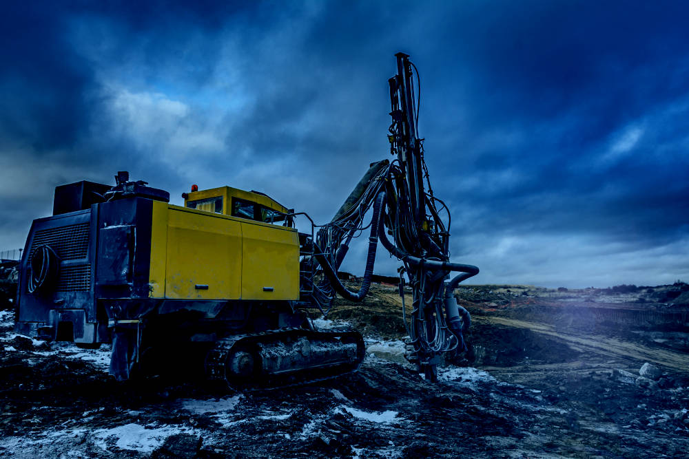 A mobile drilling rig drilling into rock